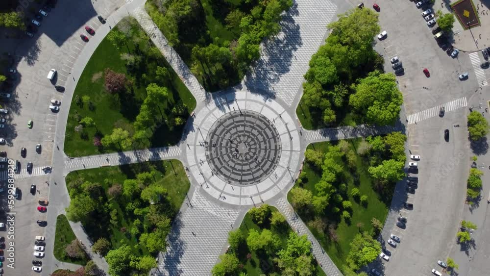 Aerial fly spiral up above Freedom Svobody Square central fountain circle with green park and streets look down. Center of Kharkiv city, Ukraine Aerial fly spiral up above Freedom Svobody Square central fountain circle with green park and streets look down. Center of Kharkiv city, Ukraine