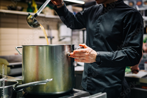 chef cooking soup on restaurant kitchen