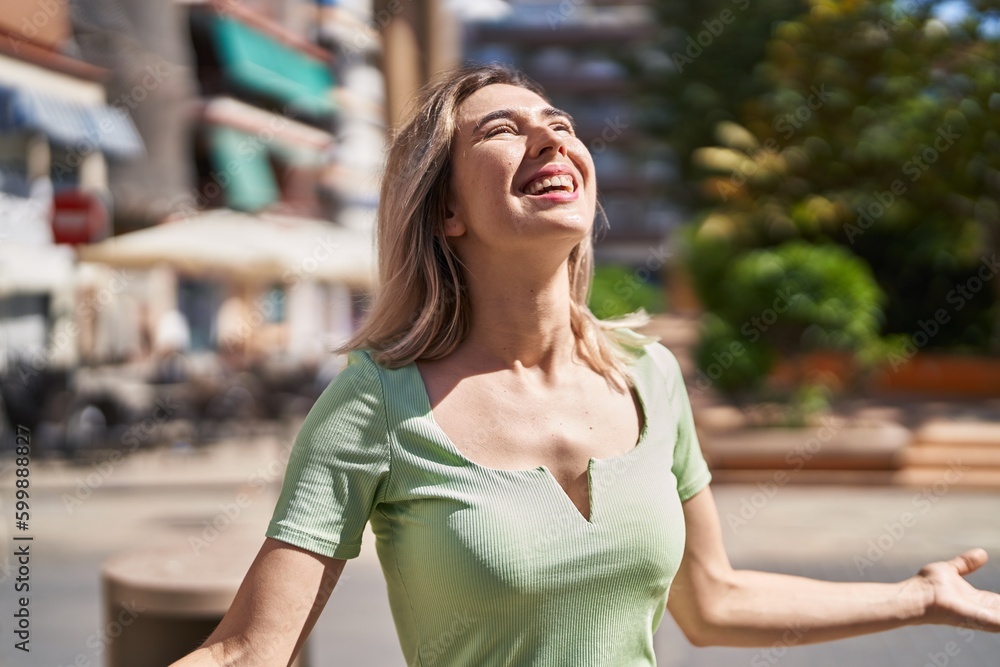 Young woman smiling confident looking to the sky at park