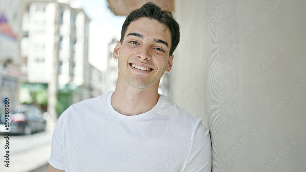 Fototapeta premium Young hispanic man smiling confident standing at street