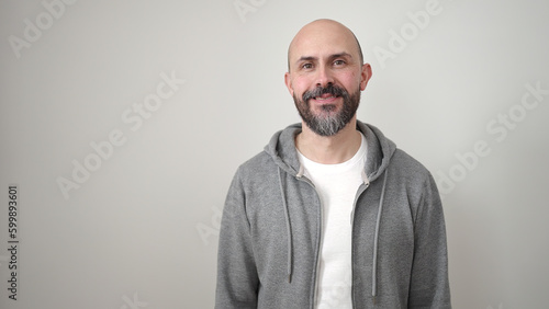 Tableau sur toile Young bald man smiling confident standing over isolated white background