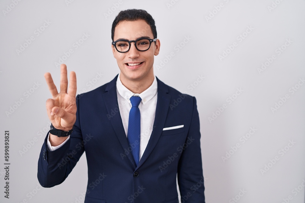 Young hispanic man wearing suit and tie showing and pointing up with fingers number three while smiling confident and happy. Young hispanic man wearing suit and tie showing and pointing up with fingers number three while smiling confident and happy.