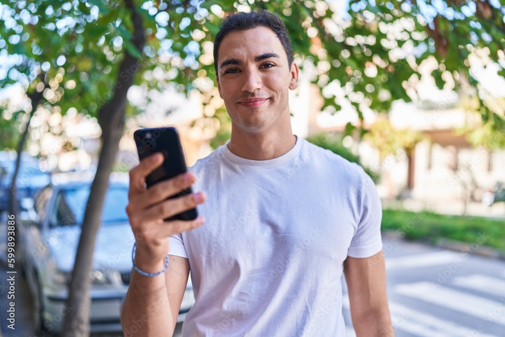 Young hispanic man smiling confident using smartphone at street Young hispanic man smiling confident using smartphone at street