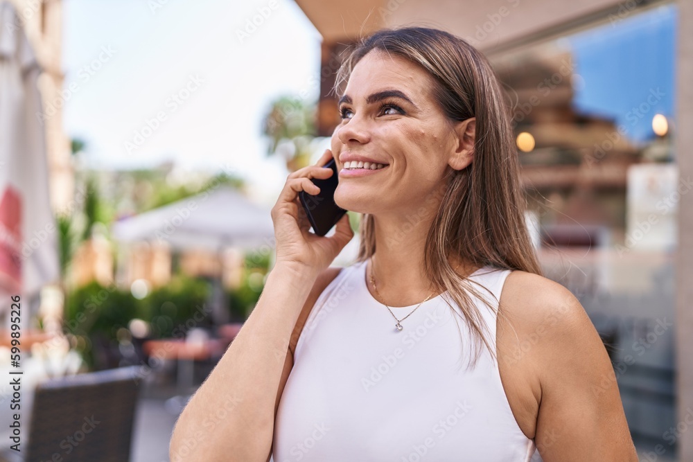 Young beautiful hispanic woman smiling confident talking on the smartphone at coffee shop terrace Young beautiful hispanic woman smiling confident talking on the smartphone at coffee shop terrace