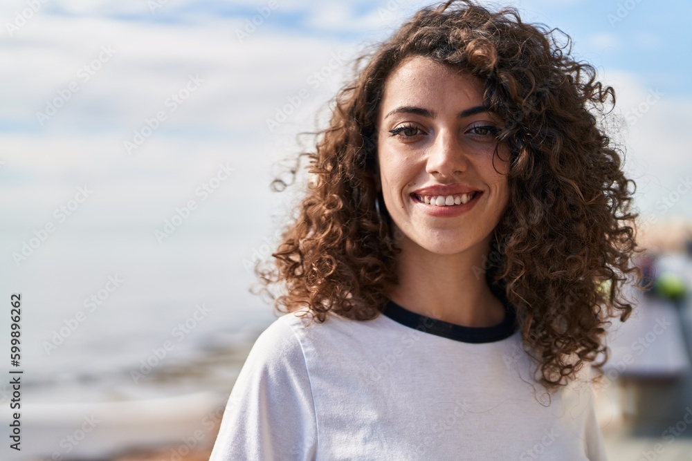 Young hispanic woman smiling confident standing at seaside Young hispanic woman smiling confident standing at seaside