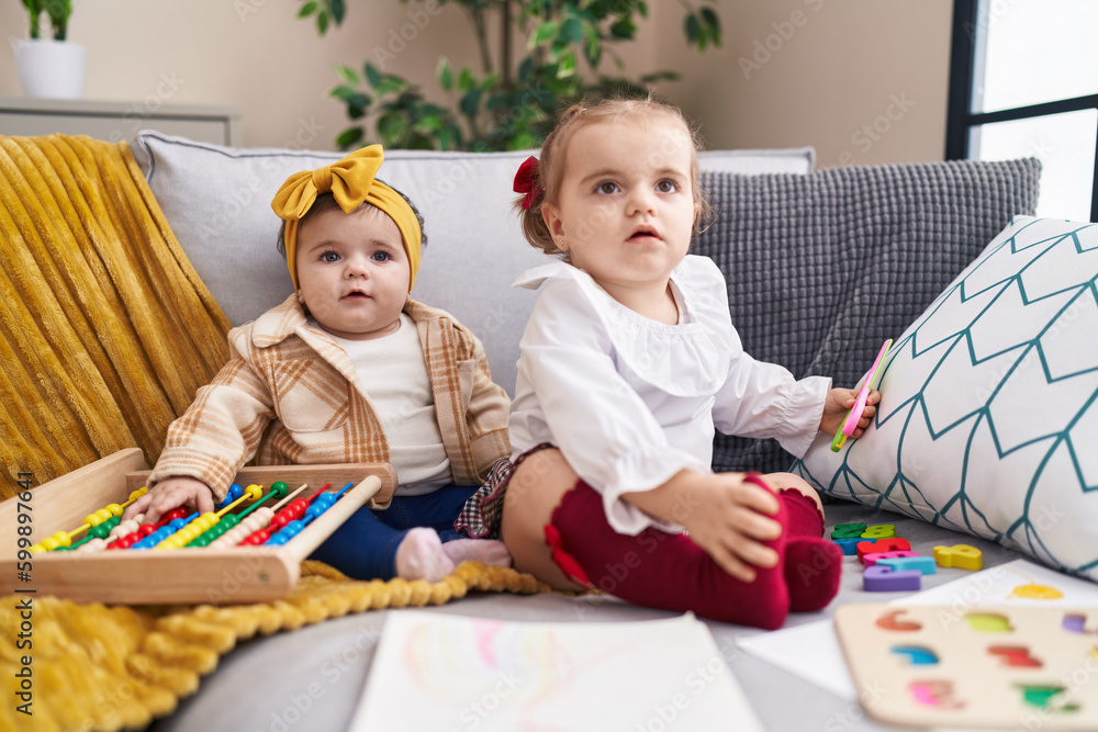 Adorable girls playing with abacus holding scissors at home Adorable girls playing with abacus holding scissors at home