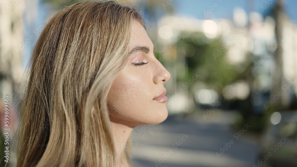 Young blonde woman breathing with closed eyes at street Young blonde woman breathing with closed eyes at street