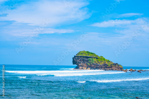 Beautiful Watukarung Beach in Pacitan, Indonesia with rocks on the ocean.