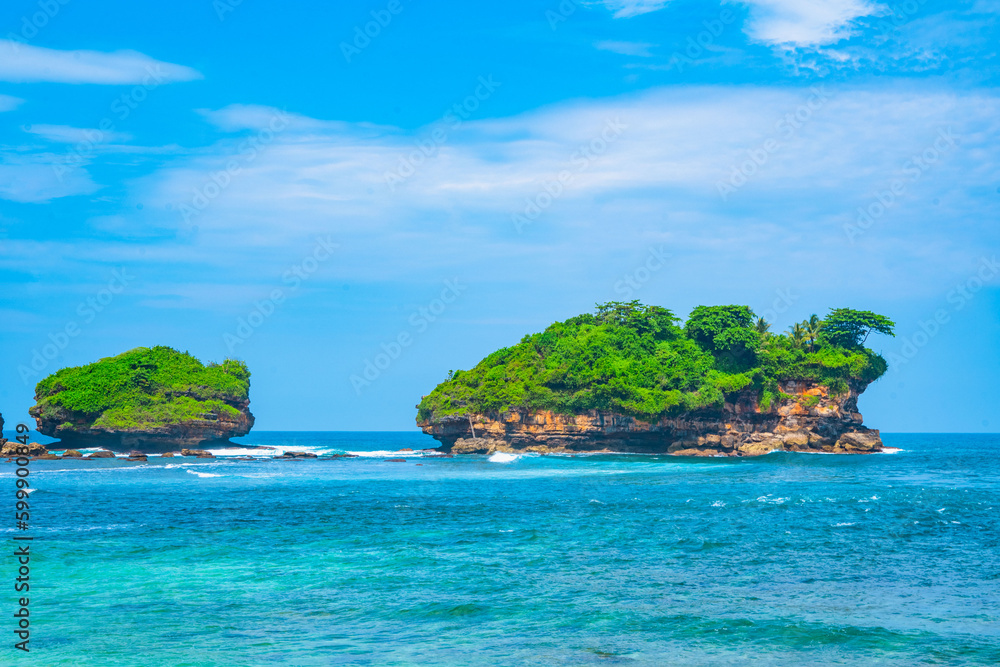 Fototapeta premium Beautiful Watukarung Beach in Pacitan, Indonesia with rocks on the ocean.