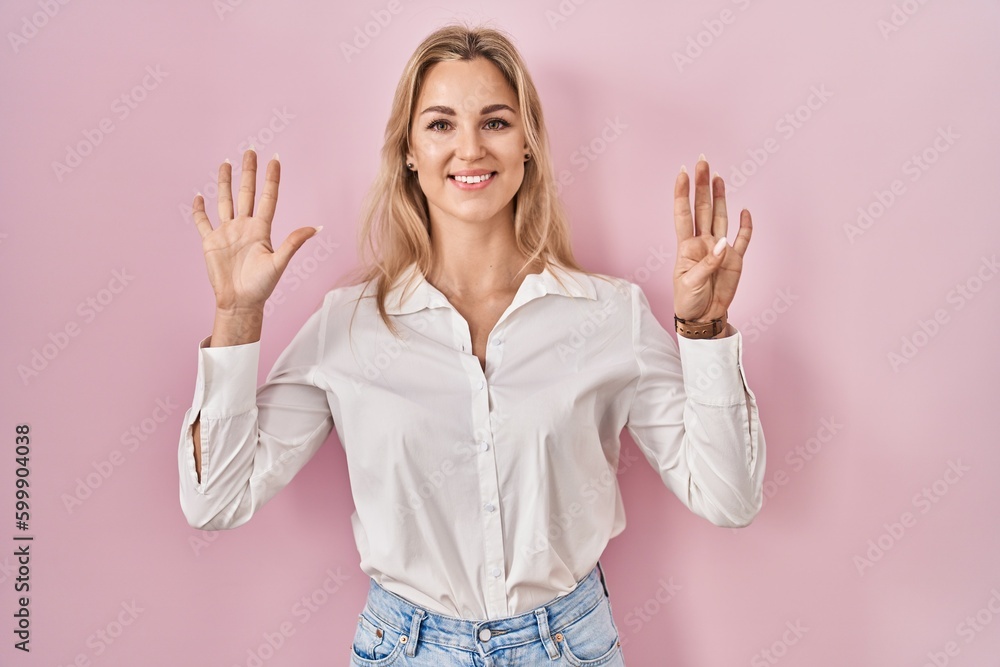 Young caucasian woman wearing casual white shirt over pink background showing and pointing up with fingers number nine while smiling confident and happy. Young caucasian woman wearing casual white shirt over pink background showing and pointing up with fingers number nine while smiling confident and happy.
