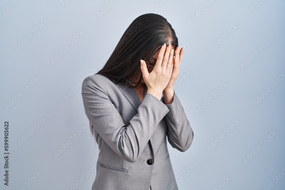 Hispanic business woman wearing glasses with sad expression covering face with hands while crying. depression concept. Hispanic business woman wearing glasses with sad expression covering face with hands while crying. depression concept.