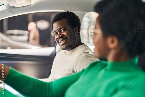 African american man and woman couple driving car at street