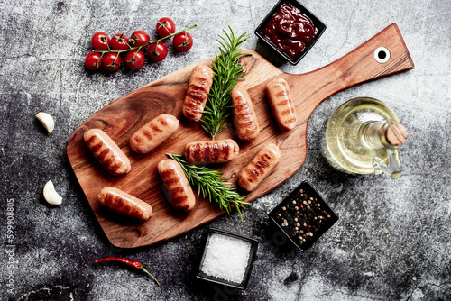 grilled sausages on a stone background 