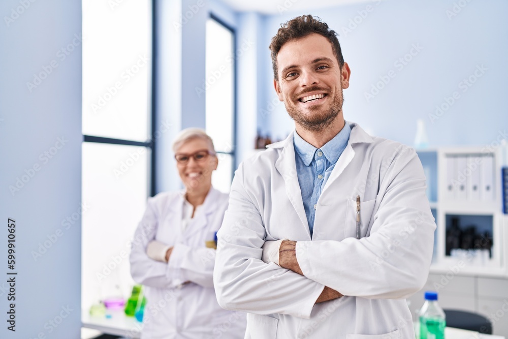 Mother and son scientist partners standing with arms crossed gesture at laboratory Mother and son scientist partners standing with arms crossed gesture at laboratory