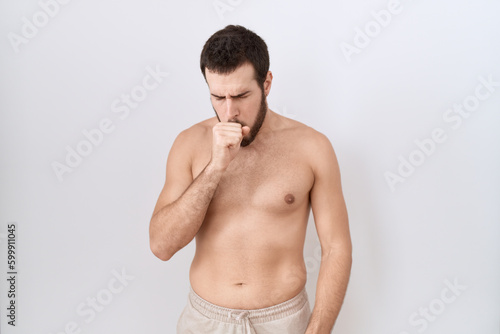 Young hispanic man standing shirtless over white background feeling unwell and coughing as symptom for cold or bronchitis. health care concept.