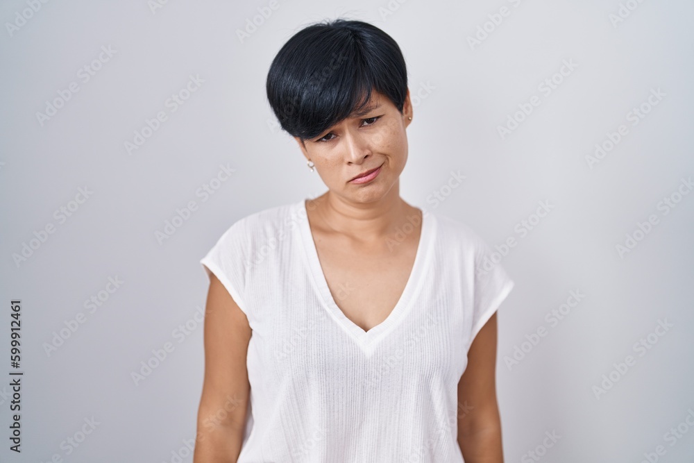 Young asian woman with short hair standing over isolated background depressed and worry for distress, crying angry and afraid. sad expression. Young asian woman with short hair standing over isolated background depressed and worry for distress, crying angry and afraid. sad expression.