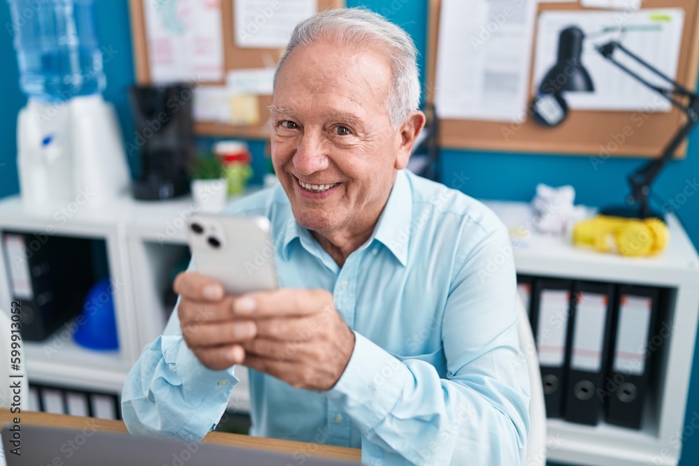 Middle age grey-haired man business worker using smartphone working at office Middle age grey-haired man business worker using smartphone working at office