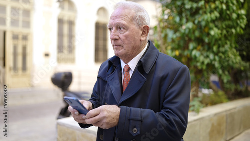 senior using smartphone at street