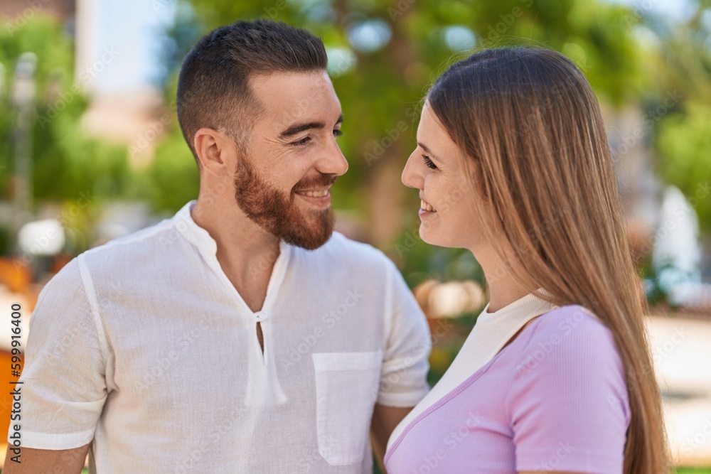 Fototapeta premium Man and woman couple smiling confident hugging each other at park