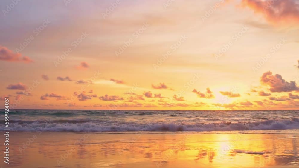 Slow motion Wave after wave crashing toward the shore in beautiful sunset..Golden sparkles in the sky shine in the water silhouette on the beach..The reflection of yellow sky shines on the beach. Slow motion Wave after wave crashing toward the shore in beautiful sunset..Golden sparkles in the sky shine in the water silhouette on the beach..The reflection of yellow sky shines on the beach.