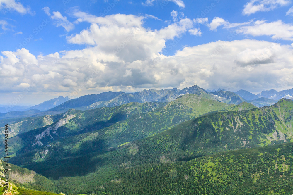 Panorama of the High Tatras (in the distance) from Mount Giewont on a sunny summer day. Kasprowy Wierch is in front of them, and the Kondratowa Valley at the bottom left.