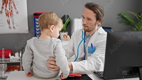 Father and son doctor examining child at clinic