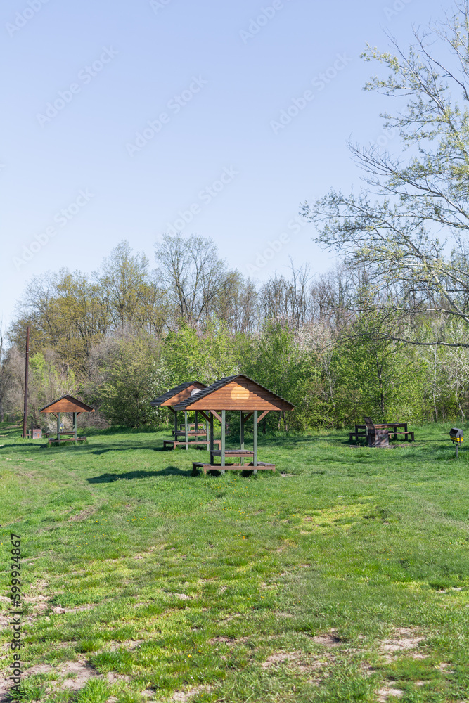 Gazebos for rest along the route. Equipped place for recreation outside the city in Iasi, Romania: gazebos, barbecue, tables and benches, trash cans. Gazebos in barbecue area in the forest Gazebos for rest along the route. Equipped place for recreation outside the city in Iasi, Romania: gazebos, barbecue, tables and benches, trash cans. Gazebos in barbecue area in the forest