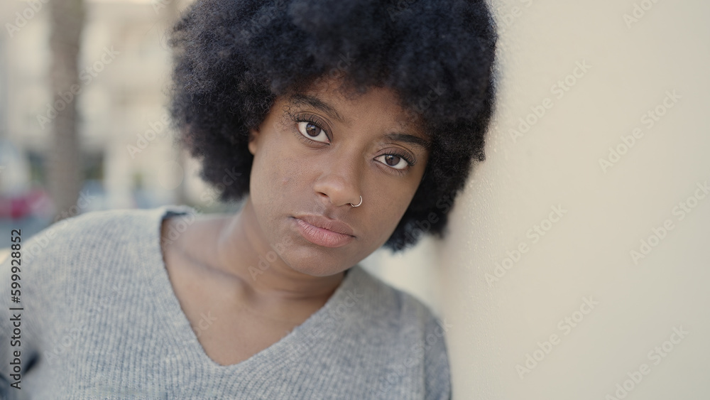 African american woman standing with sad expression at street African american woman standing with sad expression at street