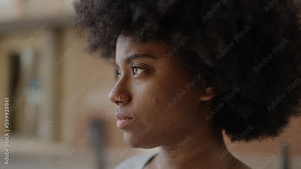 African american woman looking to the side with serious expression at street African american woman looking to the side with serious expression at street