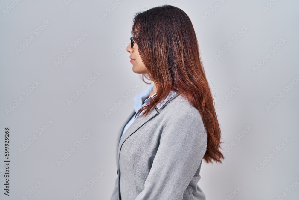 Hispanic young business woman wearing glasses looking to side, relax profile pose with natural face with confident smile. Hispanic young business woman wearing glasses looking to side, relax profile pose with natural face with confident smile.