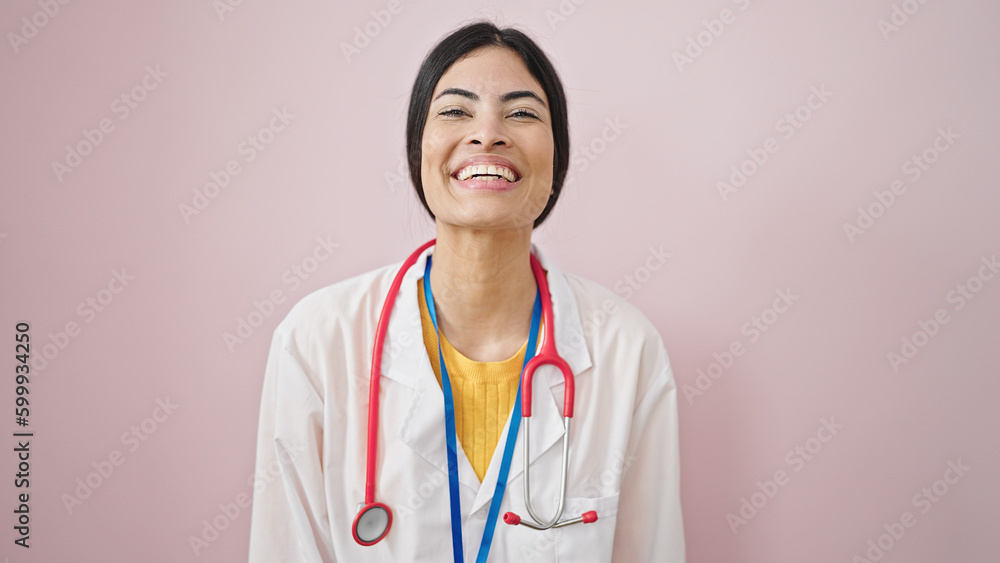 Young beautiful hispanic woman doctor smiling confident standing over isolated pink background Young beautiful hispanic woman doctor smiling confident standing over isolated pink background