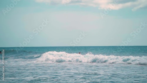 Slow Motion Surfer wiping out on small wave