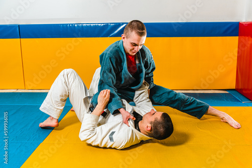 Brazilian jiu-jitsu and grappling training for men in a self-defense gym photo