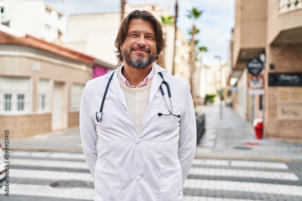 Middle age man doctor smiling confident standing at street