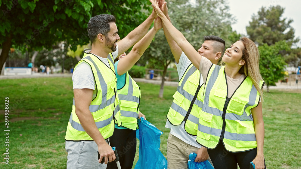 Group of people volunteers high five with hands at park Group of people volunteers high five with hands at park