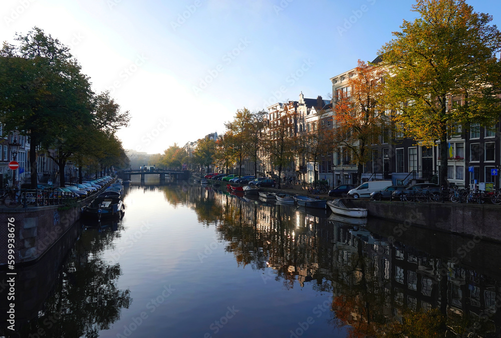 An atmospheric morning view of a canal in Amsterdam in early autumn. 