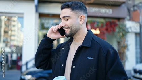 Young arab man smiling confident talking on the smartphone at street