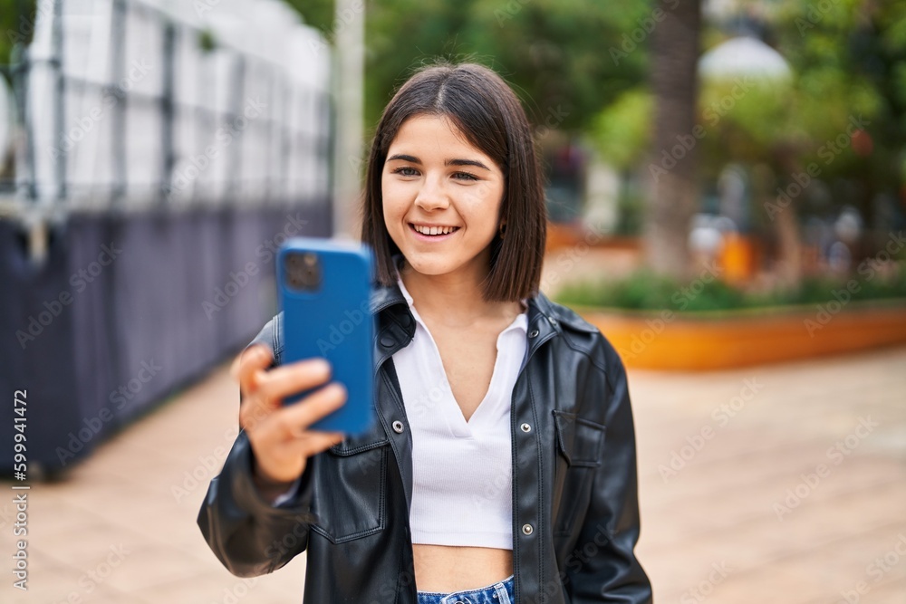 Young beautiful hispanic woman smiling confident making selfie by the smartphone at park