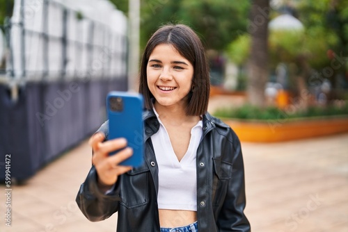 Young beautiful hispanic woman smiling confident making selfie by the smartphone at park