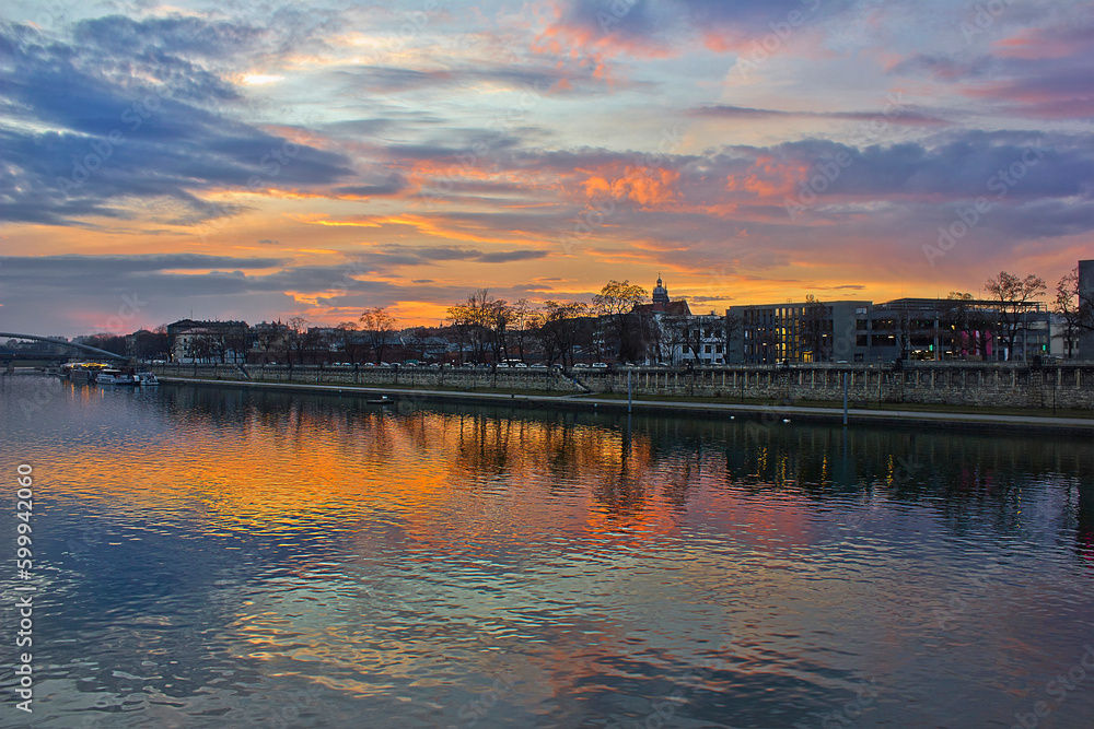 a bright colourful sunset over the Vistula River in Krakow, Poland. A city evening landscape