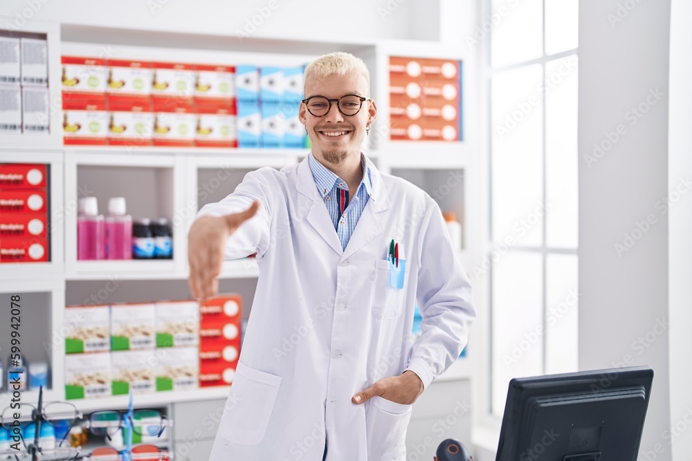 Young caucasian man pharmacist shake hand at pharmacy Young caucasian man pharmacist shake hand at pharmacy