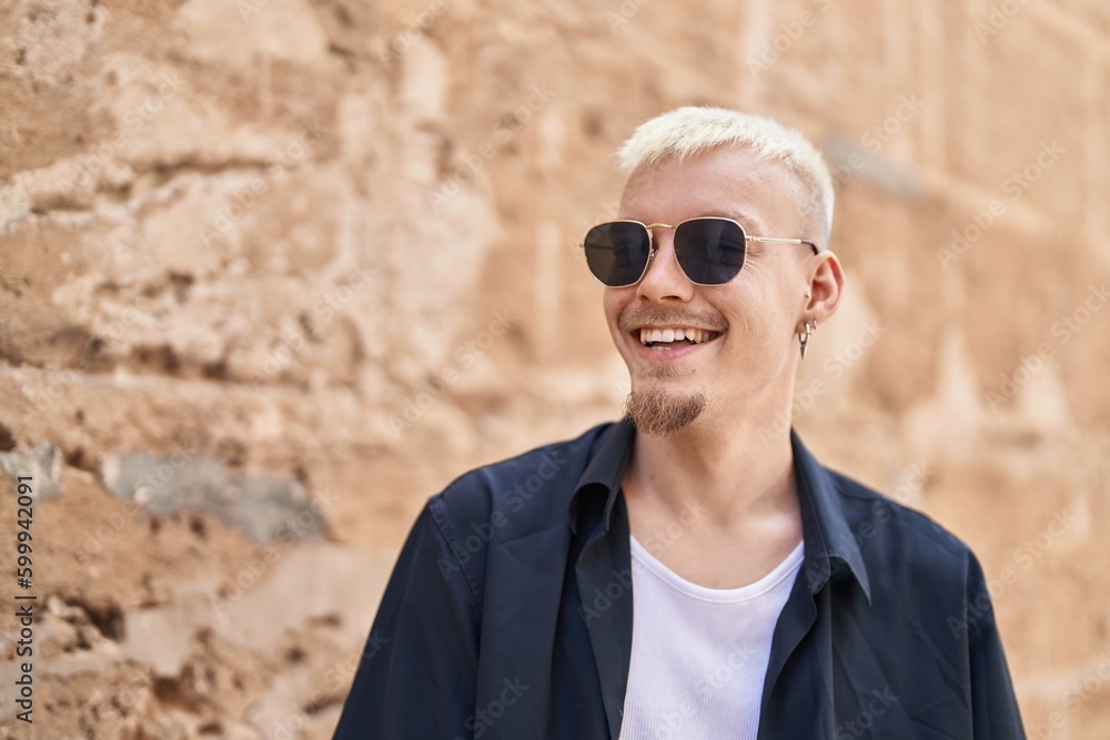 Young caucasian man smiling confident looking to the side at street Young caucasian man smiling confident looking to the side at street