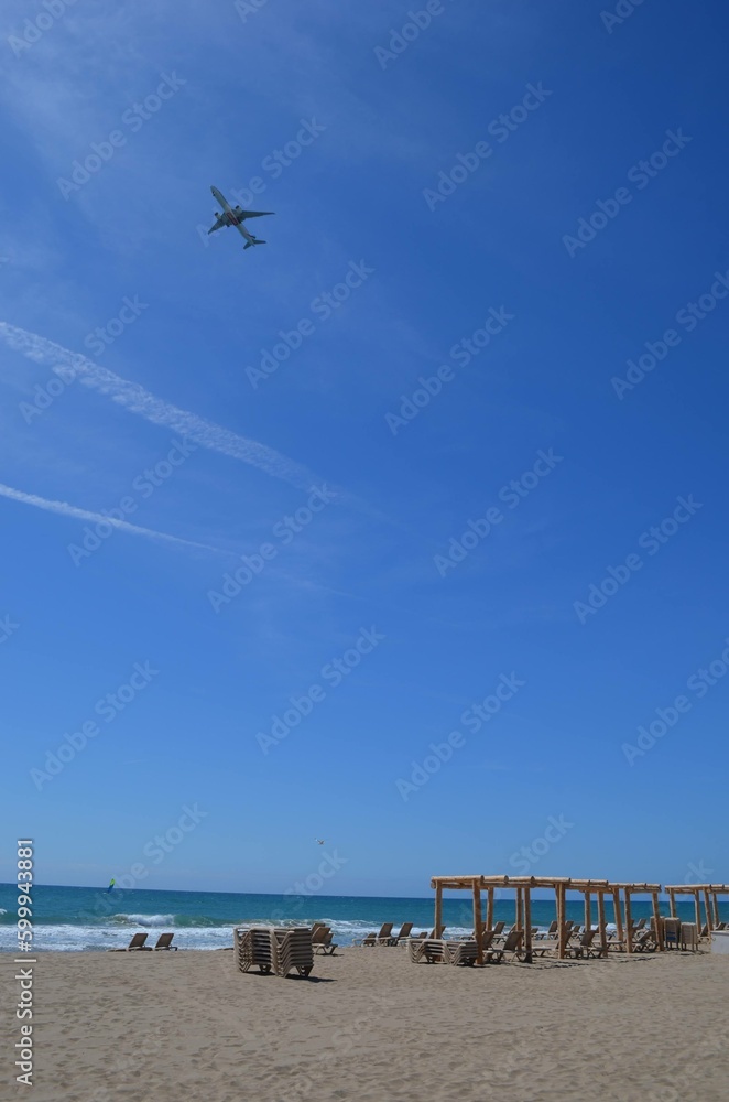 Obraz premium beach and sea with a aircraft at sky
