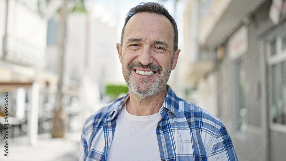 Middle age man smiling confident standing at street Middle age man smiling confident standing at street