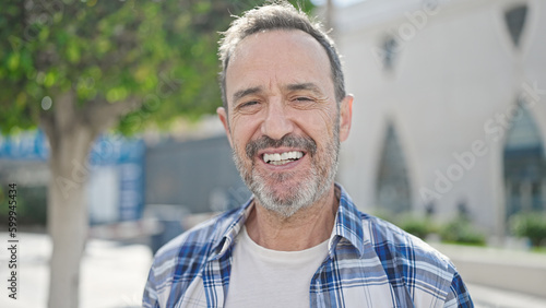 Middle age man smiling confident standing at park