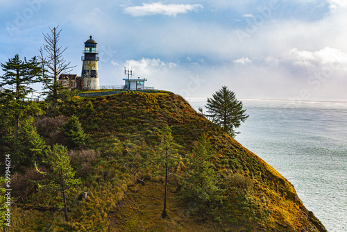 Ilwaco, Washington, USA - Decemberr 1, 2022:  Views of Cape Disappointment, lighthouse, cliffs and jetty at the conflluence of the Columbia River into the Pacific Ocean.