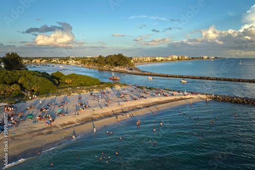 Aerial view of Nokomis beach in Sarasota County, USA. Many people enjoing vacation time swimming in gulf water and relaxing on warm Florida sun at sunset photo