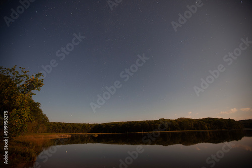 Night sky over a lake captured with an extended exposure.