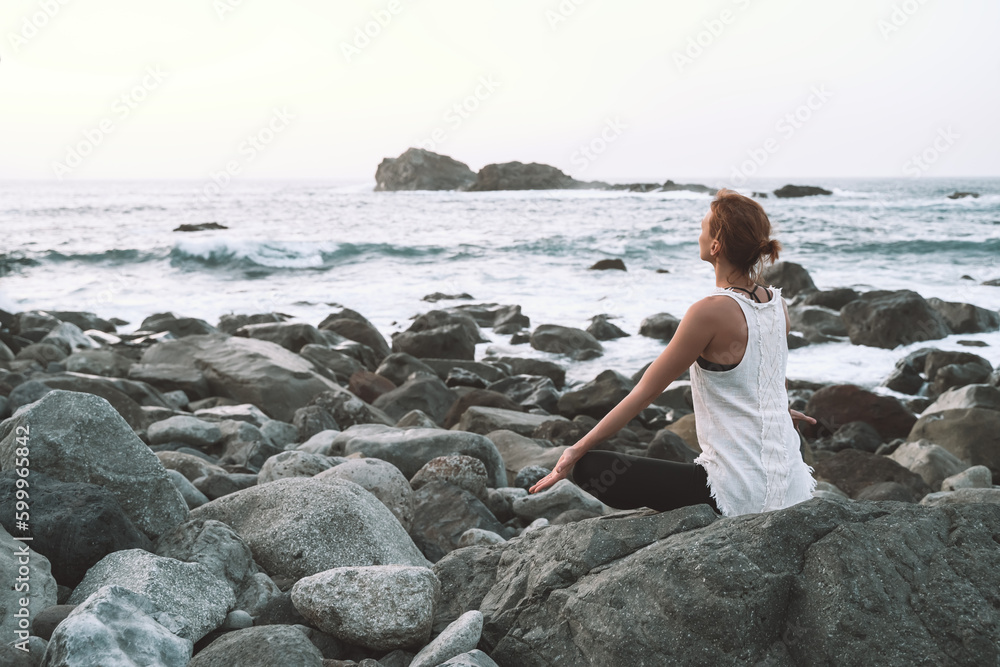 Woman is practicing yoga, meditating on the beach. Woman is practicing yoga, meditating on the beach.