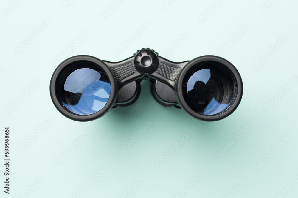 Black binoculars on color background. Top view Black binoculars on color background. Top view